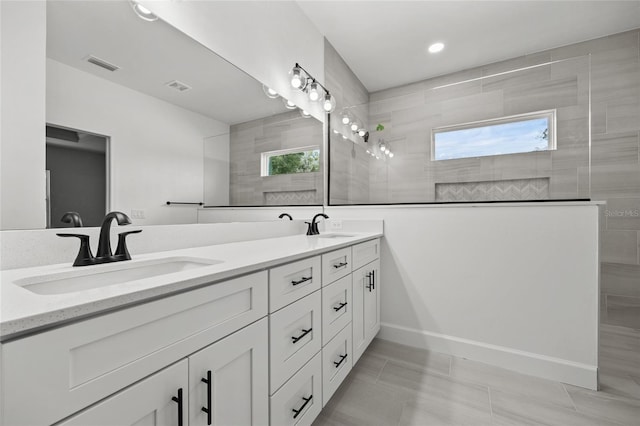 bathroom featuring vanity and a tile shower