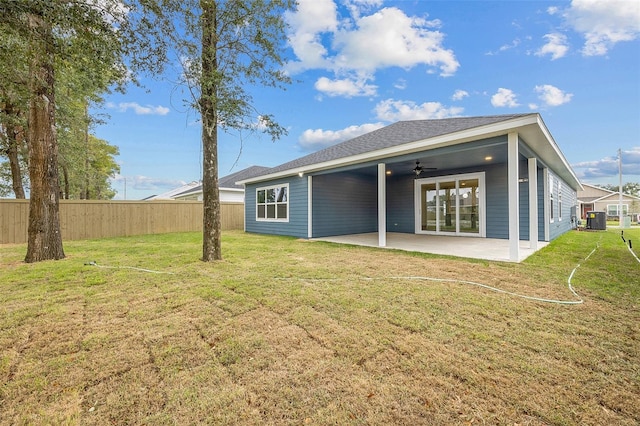 rear view of property with ceiling fan, a yard, a patio area, and central air condition unit