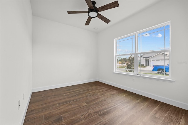 empty room featuring dark hardwood / wood-style flooring and ceiling fan