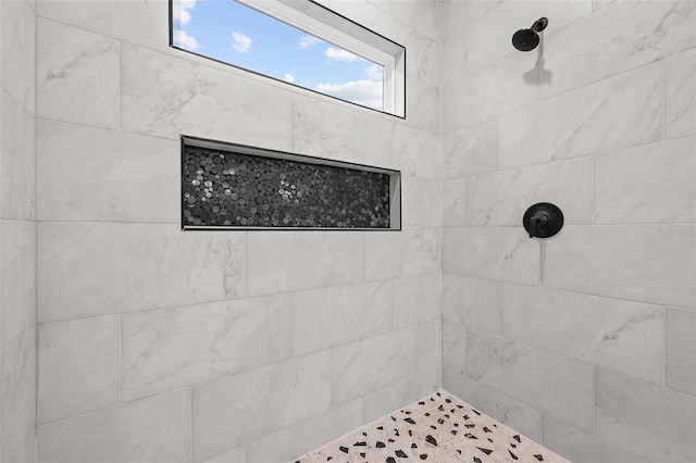 bathroom with a tile shower