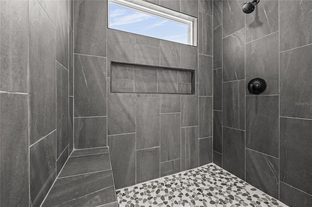 bathroom with tiled shower