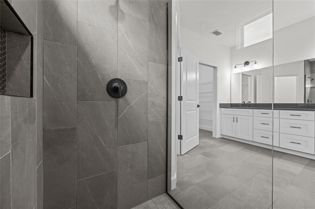 bathroom featuring vanity and a tile shower