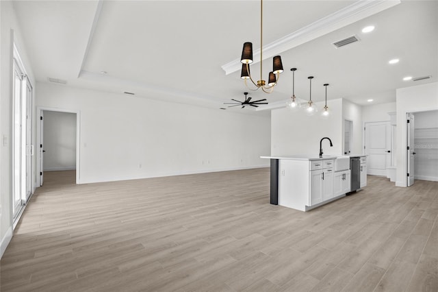 kitchen with stainless steel dishwasher, pendant lighting, a center island with sink, white cabinets, and ceiling fan with notable chandelier