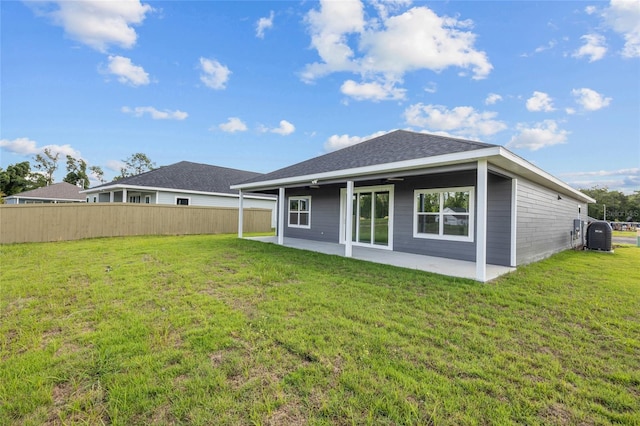 back of house with a lawn and a patio area