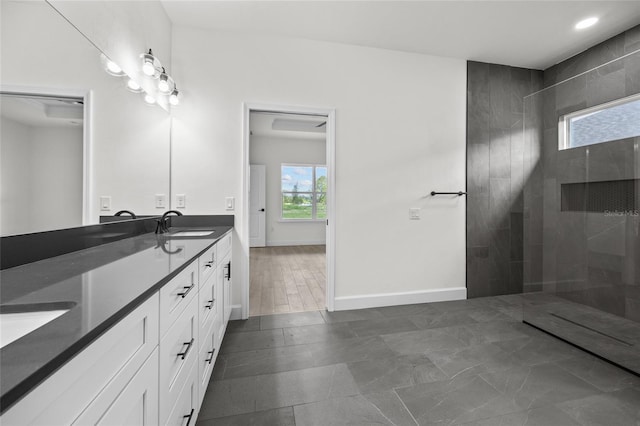 bathroom with vanity and tiled shower