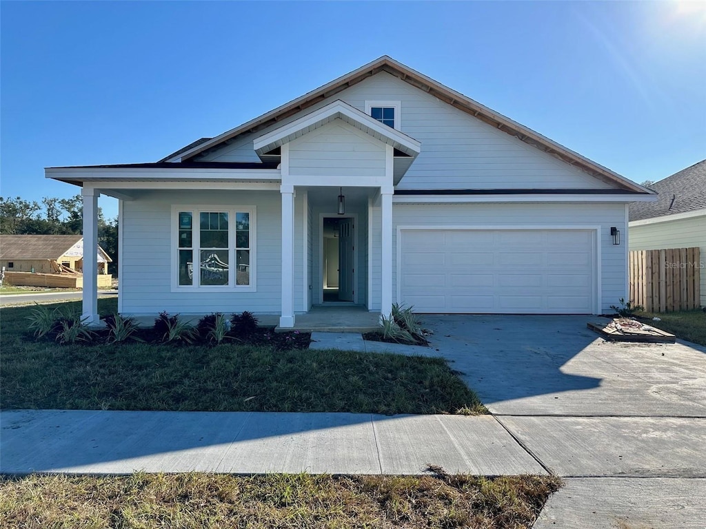 view of front of home featuring covered porch and a garage