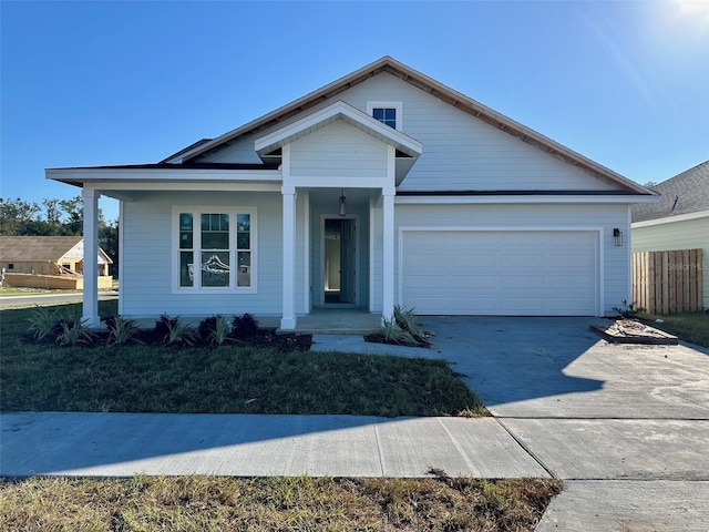 view of front of home featuring covered porch and a garage