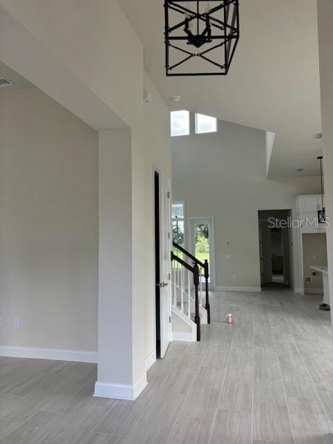 unfurnished living room with a high ceiling