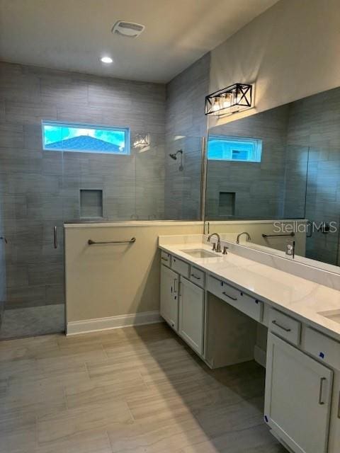 bathroom with vanity, walk in shower, and tile patterned floors