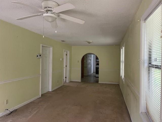 spare room featuring a textured ceiling and ceiling fan