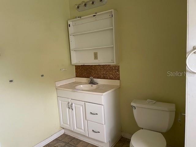 bathroom featuring oversized vanity, toilet, and tile flooring