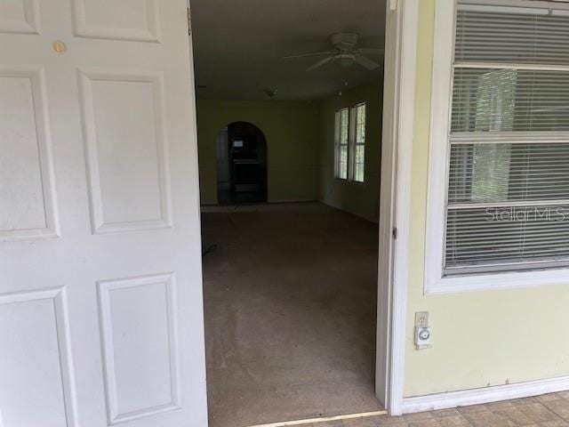 doorway to property featuring ceiling fan