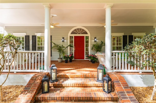 view of exterior entry with ceiling fan and covered porch