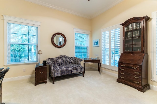 living area featuring carpet flooring, ornamental molding, and a healthy amount of sunlight