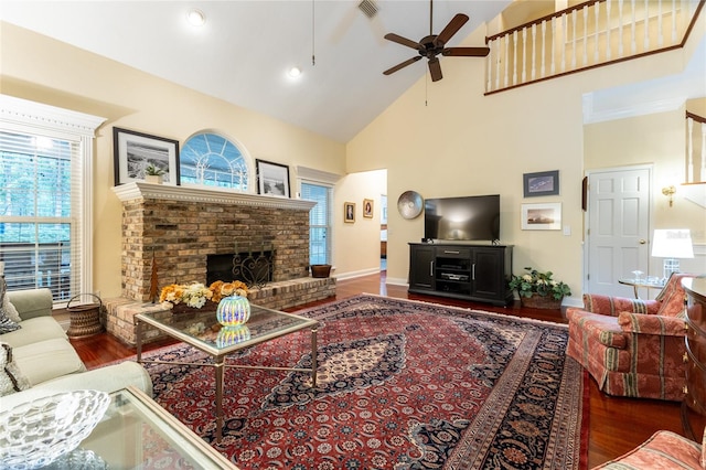 living room featuring high vaulted ceiling, dark wood-type flooring, a brick fireplace, and ceiling fan