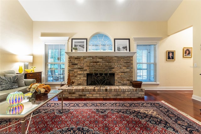 living room with a healthy amount of sunlight, a fireplace, and hardwood / wood-style floors