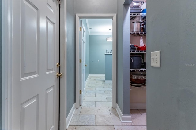 hall featuring crown molding and light tile floors