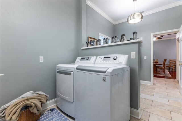 laundry room with independent washer and dryer, light tile flooring, and crown molding