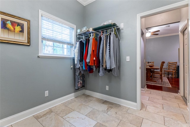 spacious closet with ceiling fan and light tile floors