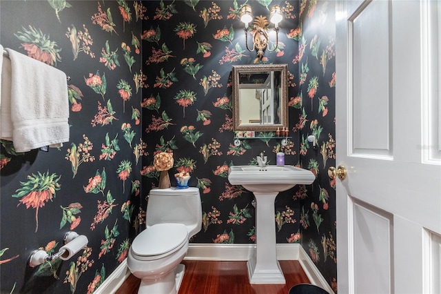 bathroom featuring wood-type flooring and toilet