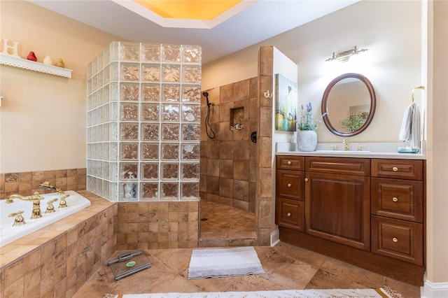 bathroom featuring a raised ceiling, tile flooring, shower with separate bathtub, and vanity