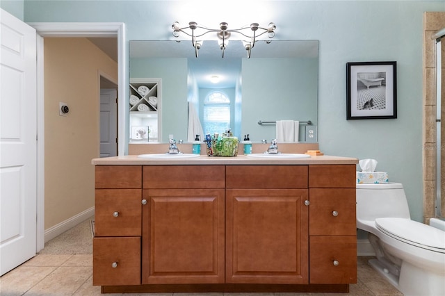 bathroom with tile floors, a notable chandelier, double vanity, and toilet