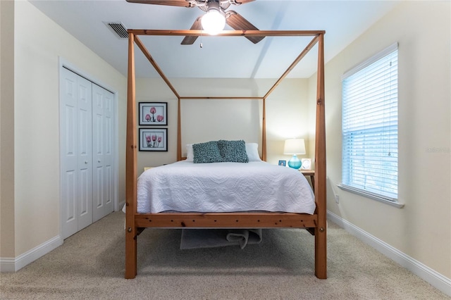 bedroom with a closet, ceiling fan, and carpet floors