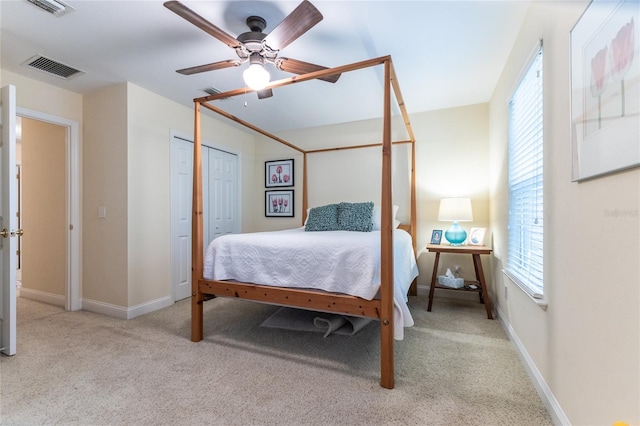 carpeted bedroom with a closet and ceiling fan