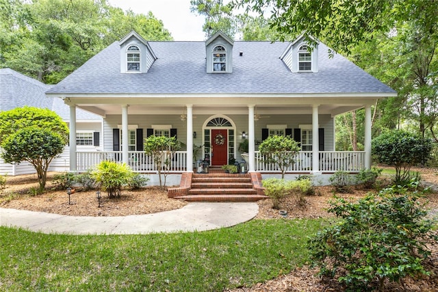 cape cod home featuring a porch