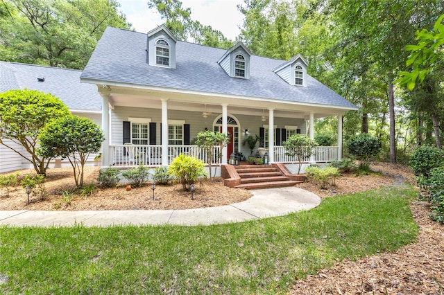 cape cod house featuring covered porch