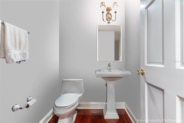 7108 NW 41st Ln, Gainesville, FL 32606 - bathroom with toilet, wood finished floors, and baseboards