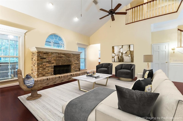 7108 NW 41st Ln, Gainesville, FL 32606 - living room featuring high vaulted ceiling, wood finished floors, a fireplace, a ceiling fan, and recessed lighting