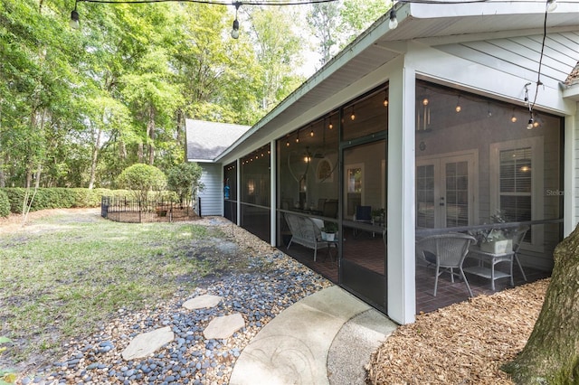7108 NW 41st Ln, Gainesville, FL 32606 - view of yard featuring a sunroom, a patio area, and french doors