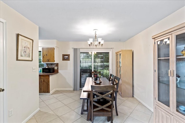 tiled dining space with a notable chandelier