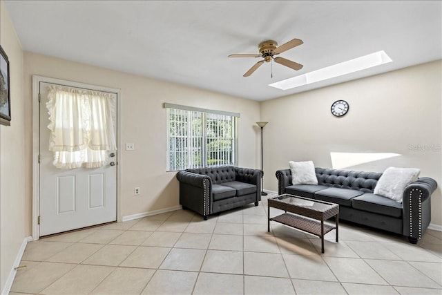 living room with light tile flooring, ceiling fan, and a skylight