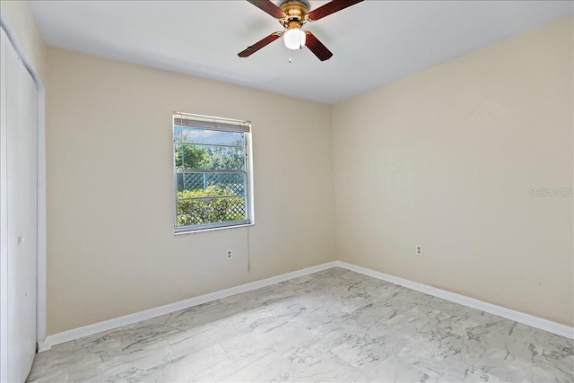 tiled spare room with ceiling fan