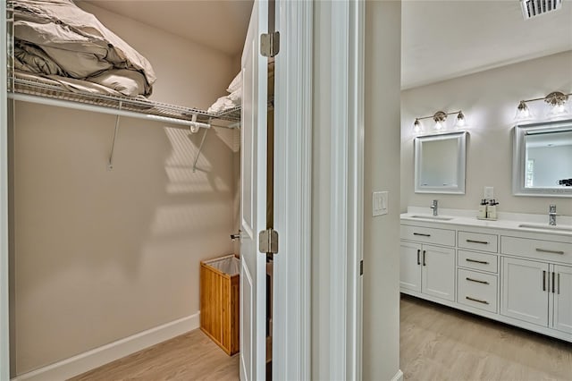 bathroom featuring dual vanity and hardwood / wood-style flooring