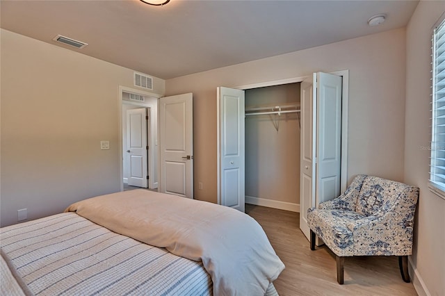 bedroom with hardwood / wood-style floors and a closet