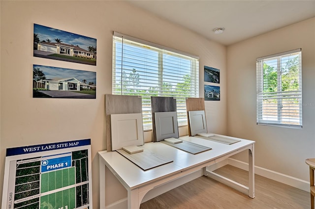 office area with plenty of natural light and light hardwood / wood-style floors