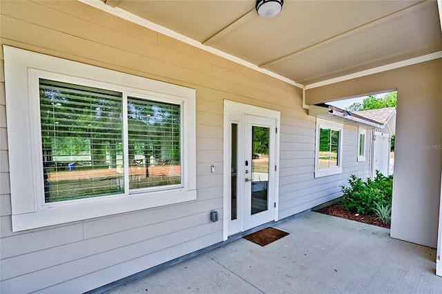 view of exterior entry with french doors and a patio