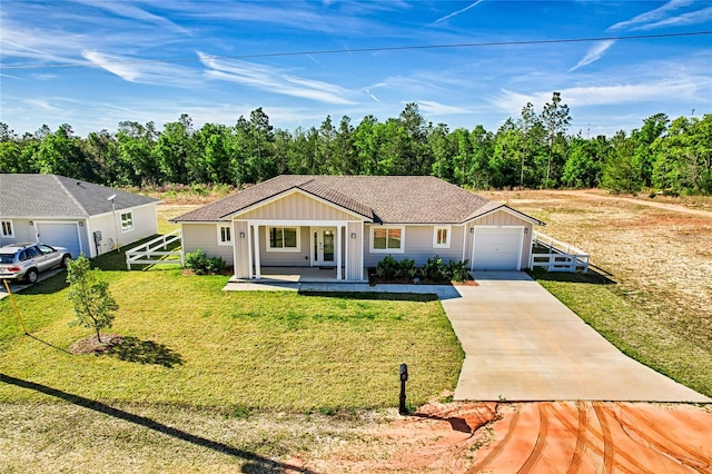 ranch-style home featuring covered porch and a front lawn