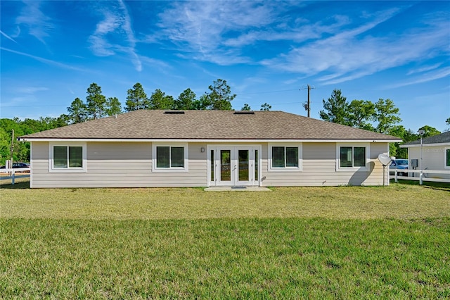 rear view of property featuring a yard and french doors