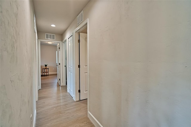 hallway with light hardwood / wood-style flooring