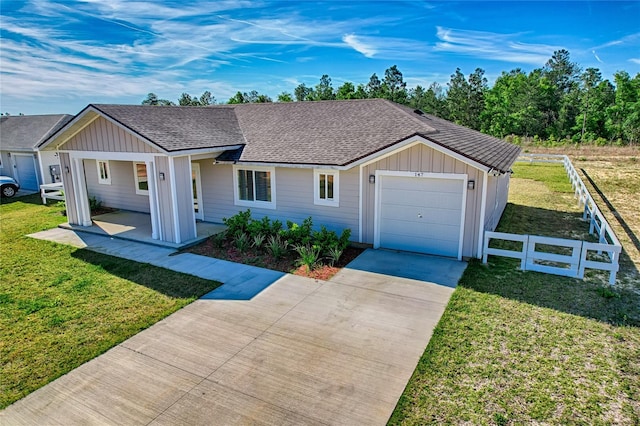 ranch-style house featuring a front yard and a garage