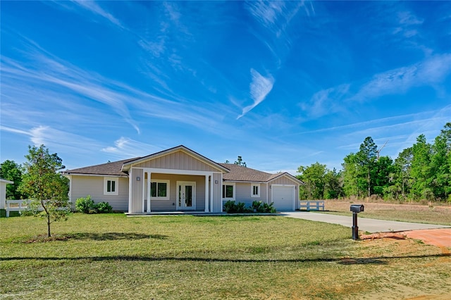 ranch-style house featuring a porch, a front yard, and a garage