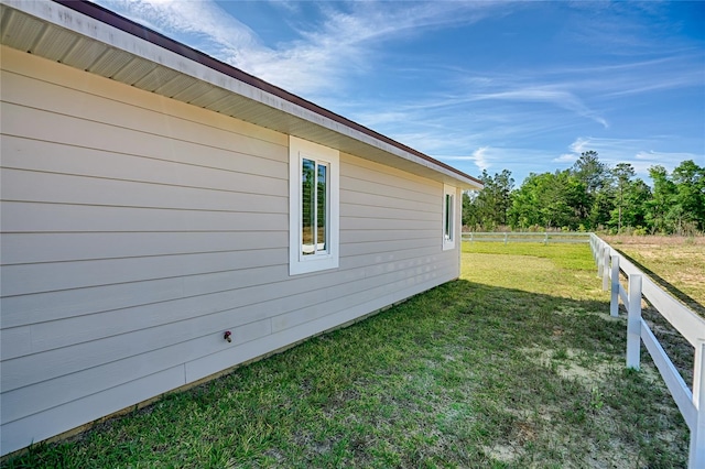 view of side of property featuring a yard