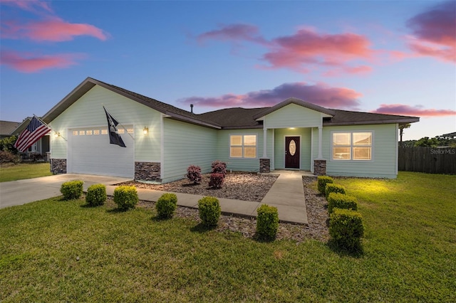 single story home with a lawn and a garage