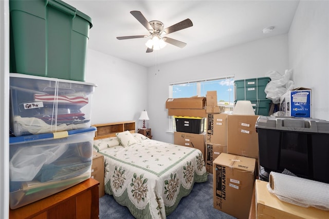 bedroom featuring ceiling fan and dark carpet