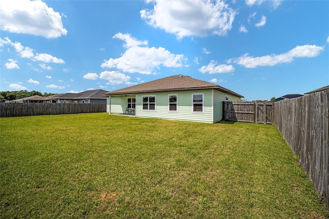 rear view of house with a lawn