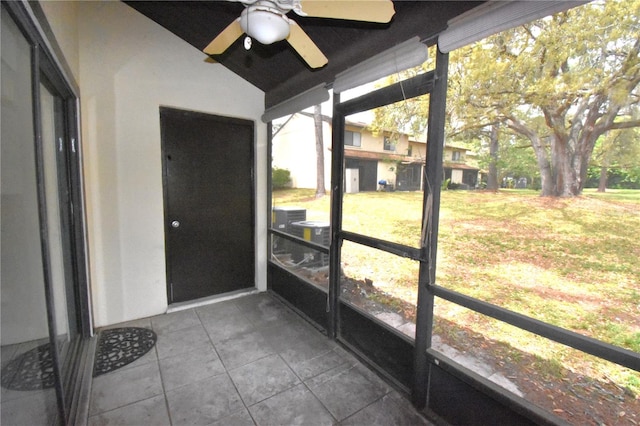 unfurnished sunroom with a wealth of natural light and ceiling fan